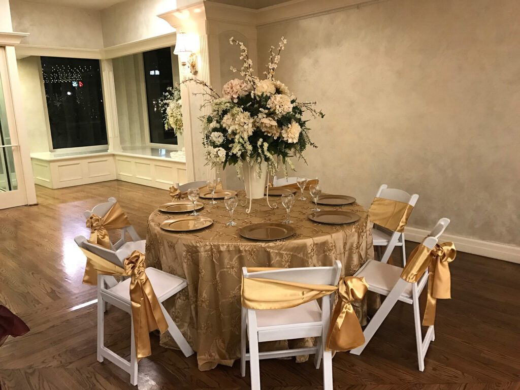 Beautiful golden and white table with white wooden chairs
