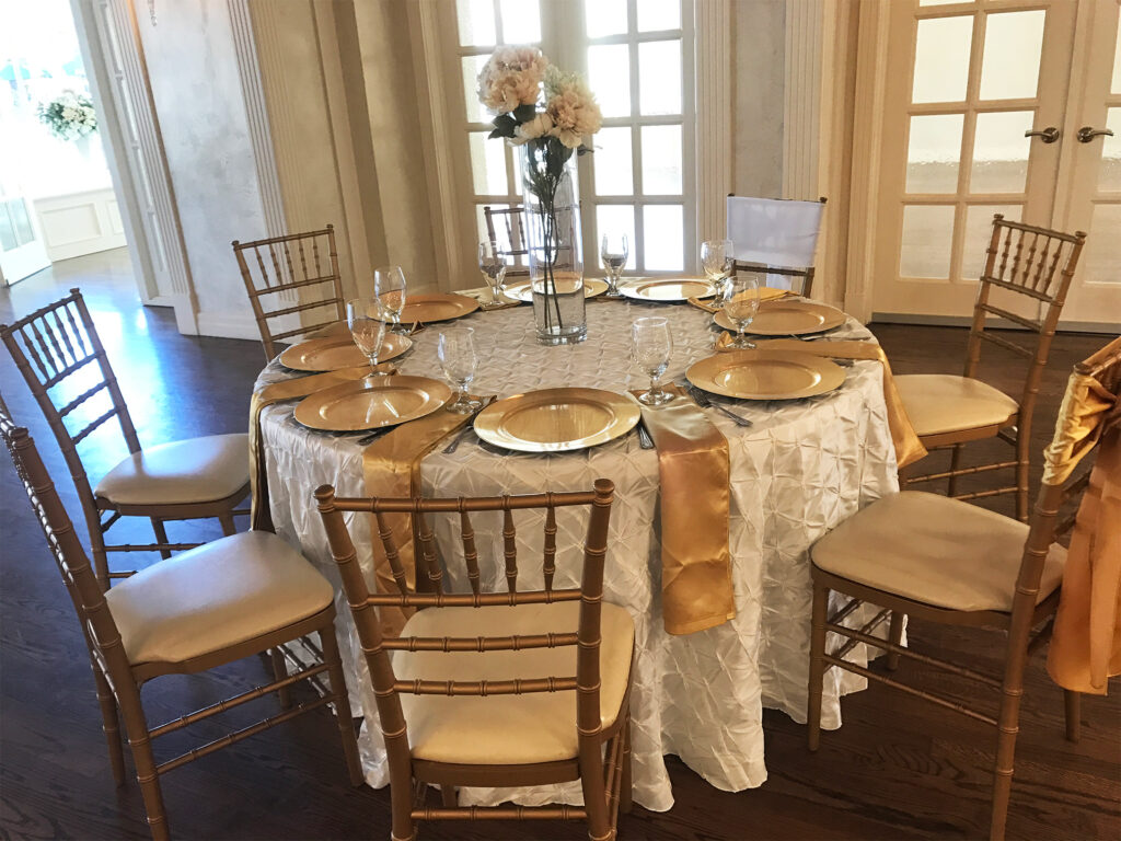 White and gold table with matching metallic chairs