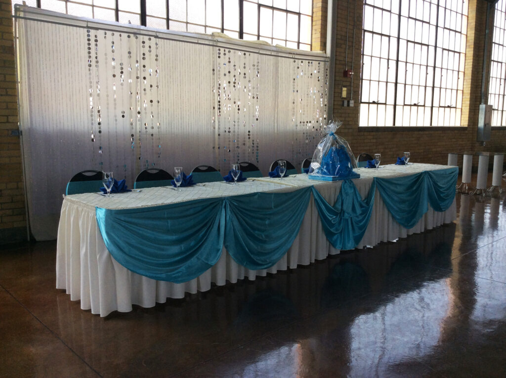 Elongated table decorated with a quinceanera doll